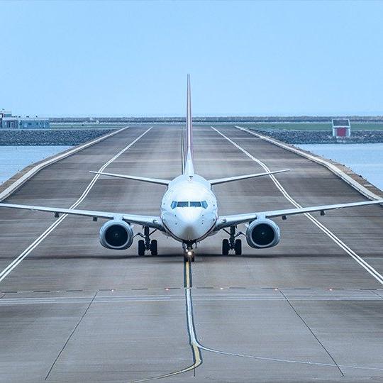 Front-view of a plane coming down the runway